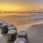 Bild Ostseestrand mit Sonnenuntergang und Seebrücke